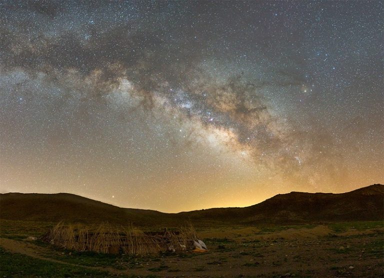 The milky way over a corral on a ranch