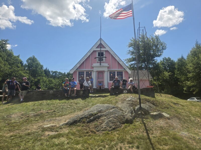 Stellafane attendees sitting in front of the Pink Clubhouse on Breezy Hill.