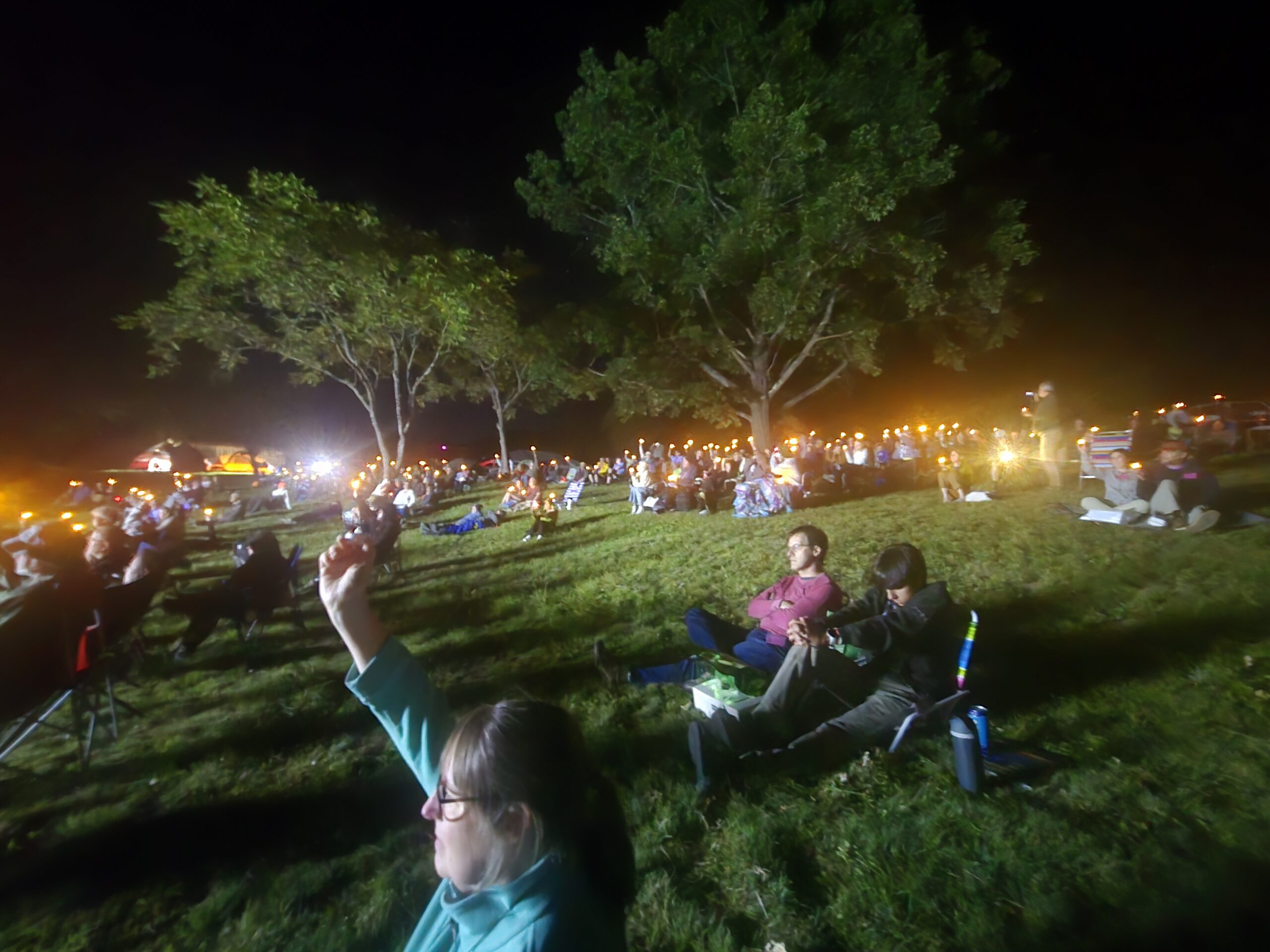 Stellafane attendees hold up candles to honor Al Nagler