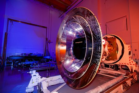 SPHEREx instrument lit in blue and red lights
