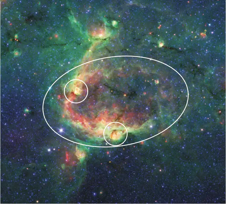 Image from Spitzer with oval shapes superimposed to identify bubble-shaped objects in the galaxy