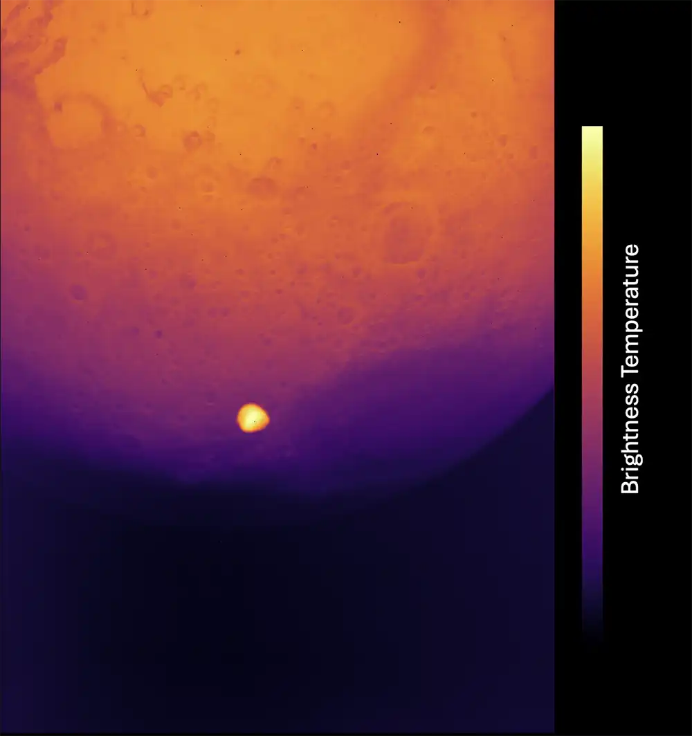 Mars appears in a gradient from deep purple to orange, while Deimos appears a much brighter orange-white