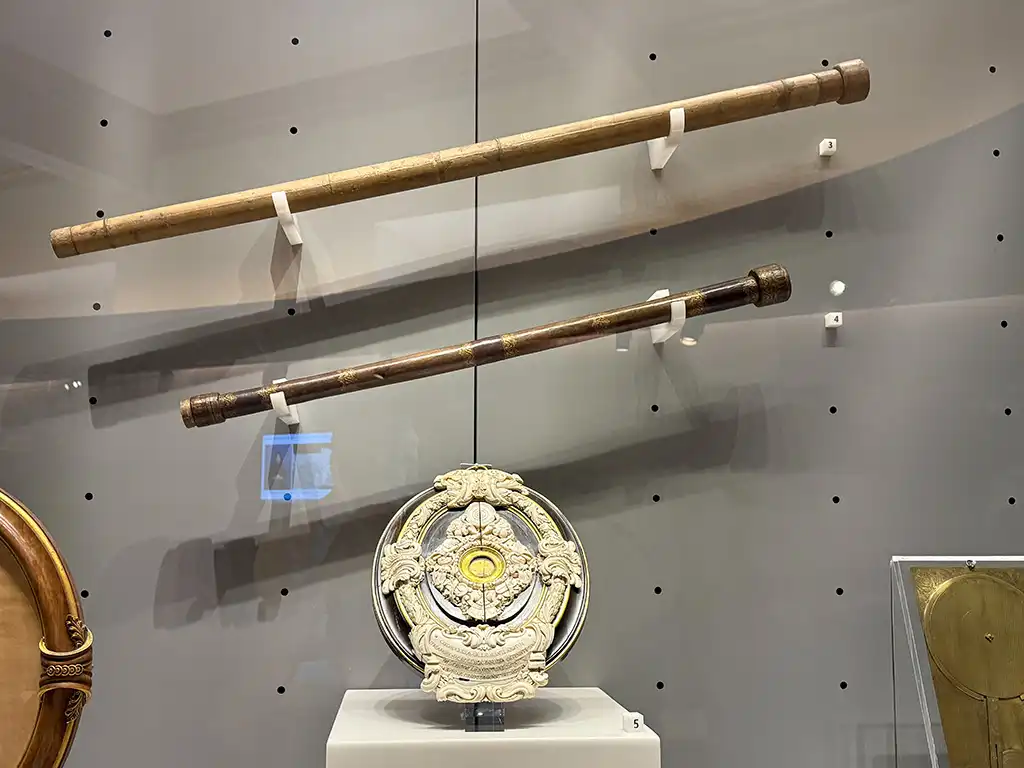 Two telescopes mounted in museum display case