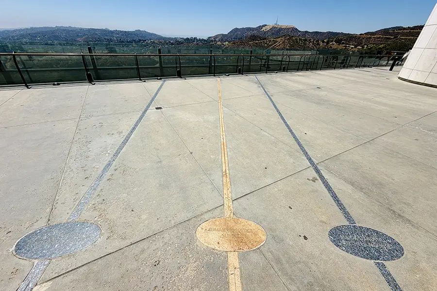 Griffith Observatory's rooftop with gold and silver lines marking celestial events