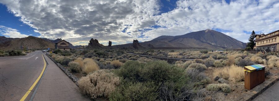 panorama of volcanic landscape, road, and hotel