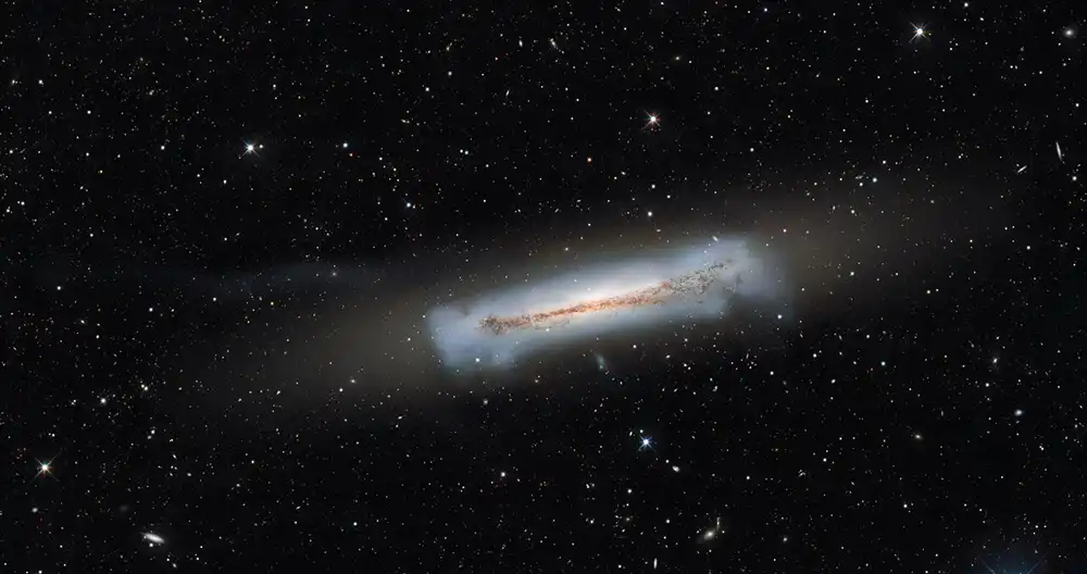 dust cuts through the center of an edge-on spiral galaxy