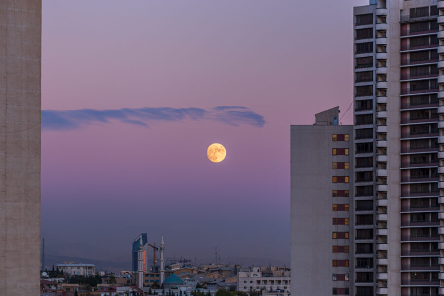 The Moon seen low through haze is honey colored. 