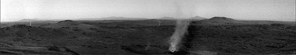 Black-and-white video shows larger dust devil subsuming a smaller dust devil coming in from the left. In the background are the dark-colored hills of the Martian landscape