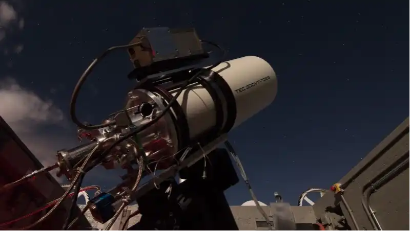 Telescope against a dark blue sky