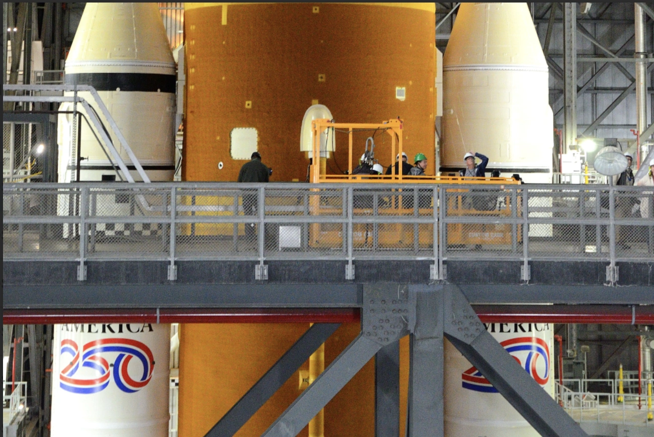 SLS rocket in the Vehicle Assembly Building, with humans for scale