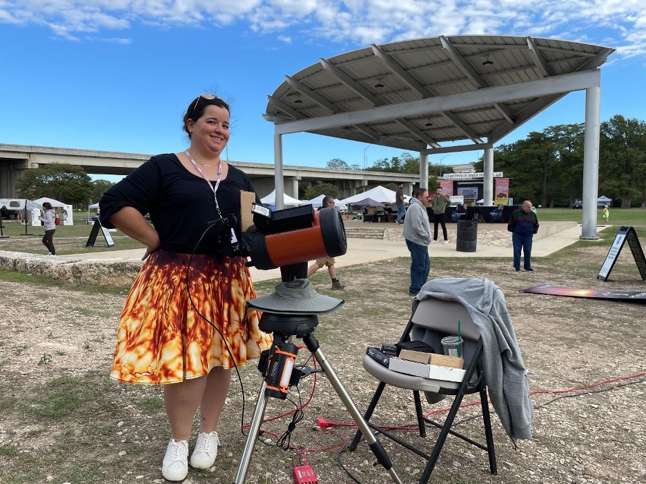 Person standing at telescope